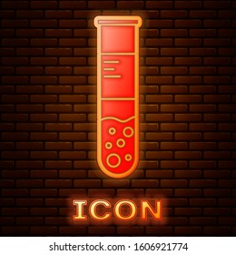 Glowing neon Test tube and flask chemical laboratory test icon isolated on brick wall background. Laboratory glassware sign.  Vector Illustration