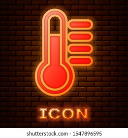 Glowing neon Thermometer icon isolated on brick wall background.  Vector Illustration
