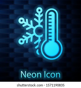 Glowing neon Thermometer with snowflake icon isolated on brick wall background.  Vector Illustration