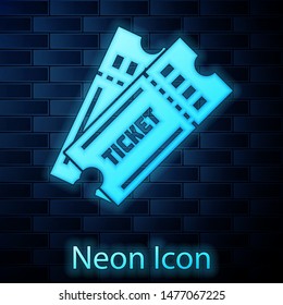 Glowing neon Ticket icon isolated on brick wall background.  Vector Illustration