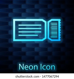 Glowing neon Ticket icon isolated on brick wall background.  Vector Illustration