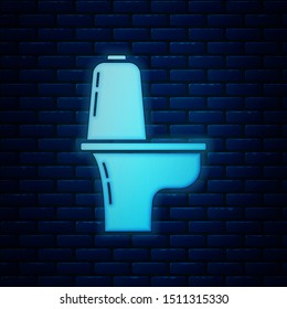 Glowing neon Toilet bowl icon isolated on brick wall background.  Vector Illustration