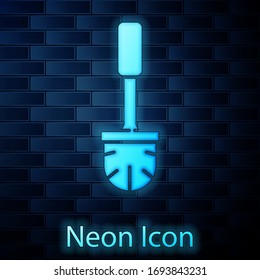 Glowing neon Toilet brush icon isolated on brick wall background. Vector Illustration