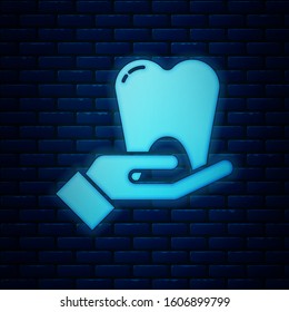 Glowing neon Tooth icon isolated on brick wall background. Tooth symbol for dentistry clinic or dentist medical center and toothpaste package.  Vector Illustration