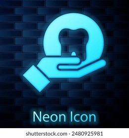Glowing neon Tooth icon isolated on brick wall background. Tooth symbol for dentistry clinic or dentist medical center and toothpaste package.  Vector