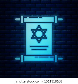 Glowing neon Torah scroll icon isolated on brick wall background. Jewish Torah in expanded form. Star of David symbol. Old parchment scroll.  Vector Illustration