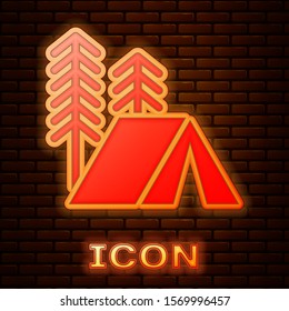 Glowing neon Tourist tent icon isolated on brick wall background. Camping symbol.  Vector Illustration