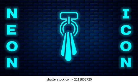 Glowing neon Towel on a hanger icon isolated on brick wall background. Bathroom towel icon.  Vector