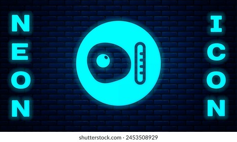 Glowing neon Traditional british breakfast, fried eggs with sausage icon isolated on brick wall background.  Vector
