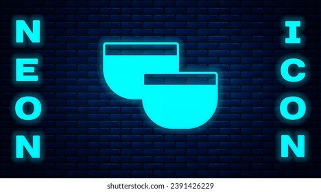 Glowing neon Traditional Chinese tea ceremony icon isolated on brick wall background. Teapot with cup.  Vector