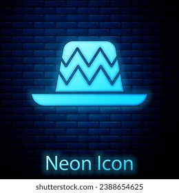 Glowing neon Traditional mexican sombrero hat icon isolated on brick wall background.  Vector