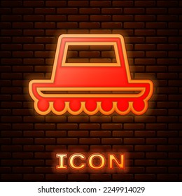 Glowing neon Traditional spanish hat icon isolated on brick wall background.  Vector