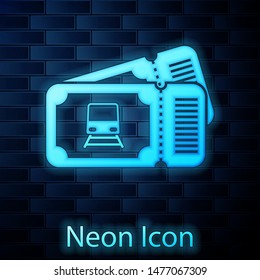 Glowing neon Train ticket icon isolated on brick wall background. Travel by railway.  Vector Illustration