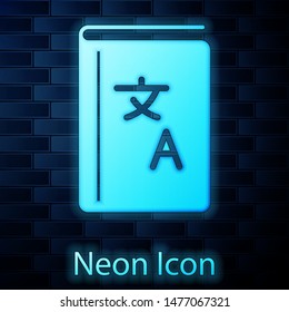 Glowing neon Translator book icon isolated on brick wall background. Foreign language conversation icons in chat speech bubble. Translating concept.  Vector Illustration