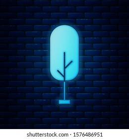 Glowing neon Tree icon isolated on brick wall background. Forest symbol.  Vector Illustration