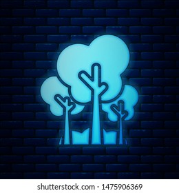 Glowing neon Trees icon isolated on brick wall background. Forest symbol.  Vector Illustration