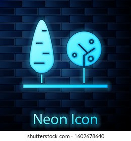 Glowing neon Trees icon isolated on brick wall background. Forest symbol.  Vector Illustration