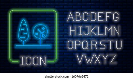 Glowing neon Trees icon isolated on brick wall background. Forest symbol. Neon light alphabet. Vector Illustration