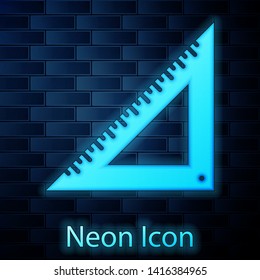 Glowing neon Triangular ruler icon isolated on brick wall background. Straightedge symbol. Geometric symbol.  Vector Illustration