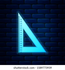 Glowing neon Triangular ruler icon isolated on brick wall background. Straightedge symbol. Geometric symbol.  Vector Illustration