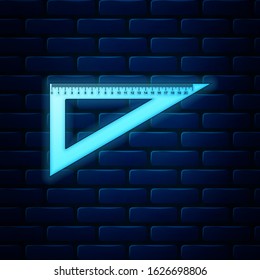 Glowing neon Triangular ruler icon isolated on brick wall background. Straightedge symbol. Geometric symbol.  Vector Illustration
