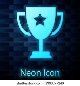 Glowing neon Trophy cup icon isolated on brick wall background. Award symbol. Champion cup icon. Vector Illustration