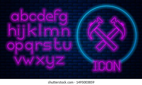 Glowing neon Two crossed hammers icon isolated on brick wall background. Tool for repair. Neon light alphabet. Vector Illustration