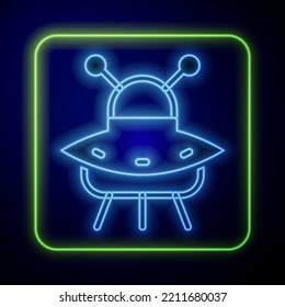 Glowing neon UFO flying spaceship icon isolated on blue background. Flying saucer. Alien space ship. Futuristic unknown flying object.  Vector