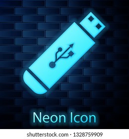 Glowing neon USB flash drive icon isolated on brick wall background. Vector Illustration