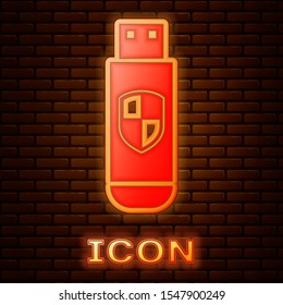 Glowing neon USB flash drive and protection shield icon isolated on brick wall background.  Vector Illustration