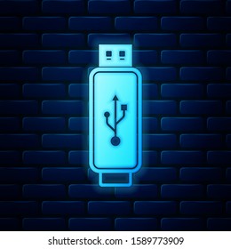 Glowing neon USB flash drive icon isolated on brick wall background.  Vector Illustration