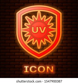 Glowing neon UV protection icon isolated on brick wall background. Sun and shield. Ultra violet rays radiation. SPF sun sign.  Vector Illustration