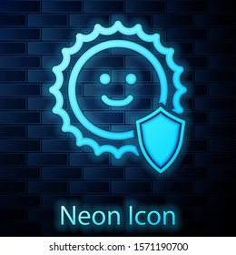 Glowing neon UV protection icon isolated on brick wall background. Sun and shield. Ultra violet rays radiation. SPF sun sign.  Vector Illustration