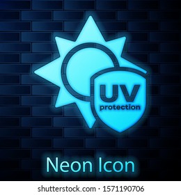 Glowing neon UV protection icon isolated on brick wall background. Sun and shield. Ultra violet rays radiation. SPF sun sign.  Vector Illustration