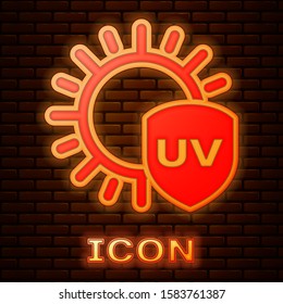 Glowing neon UV protection icon isolated on brick wall background. Sun and shield. Ultra violet rays radiation. SPF sun sign.  Vector Illustration