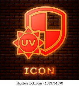 Glowing neon UV protection icon isolated on brick wall background. Sun and shield. Ultra violet rays radiation. SPF sun sign.  Vector Illustration