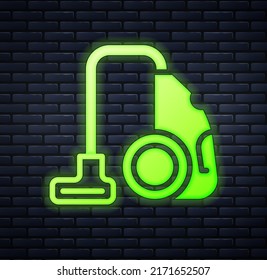 Glowing neon Vacuum cleaner icon isolated on brick wall background.  Vector
