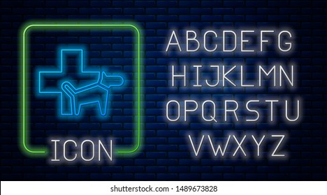 Glowing neon Veterinary clinic symbol icon isolated on brick wall background. Cross with dog veterinary care. Pet First Aid sign. Neon light alphabet. Vector Illustration