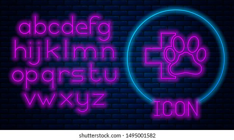 Glowing neon Veterinary clinic symbol icon isolated on brick wall background. Cross hospital sign. A stylized paw print dog or cat. Pet First Aid sign. Neon light alphabet. Vector Illustration