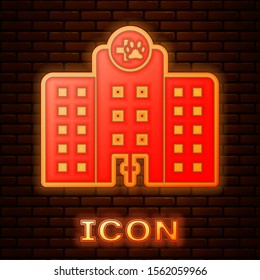 Glowing neon Veterinary medicine hospital, clinic or pet shop for animals icon isolated on brick wall background. Vet or veterinarian clinic.  Vector Illustration