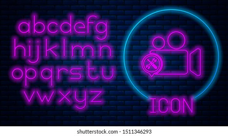 Glowing neon Video camera with screwdriver and wrench icon isolated on brick wall background. Adjusting, service, setting, maintenance, repair, fixing. Neon light alphabet. Vector Illustration