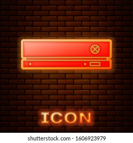 Glowing neon Video game console icon isolated on brick wall background.  Vector Illustration