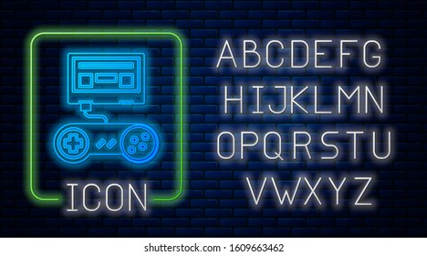 Glowing neon Video game console with joystick icon isolated on brick wall background. Neon light alphabet. Vector Illustration