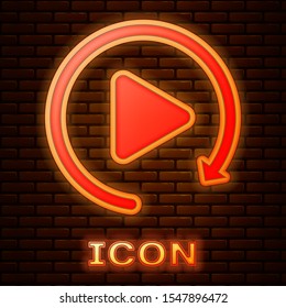 Glowing neon Video play button like simple replay icon isolated on brick wall background.  Vector Illustration