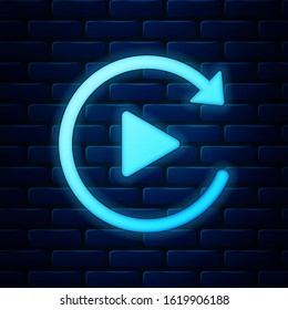 Glowing neon Video play button like simple replay icon isolated on brick wall background.  Vector Illustration