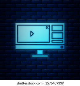 Glowing neon Video recorder or editor software on computer monitor icon isolated on brick wall background.  Vector Illustration