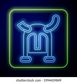 Glowing neon Viking in horned helmet icon isolated on blue background.  Vector