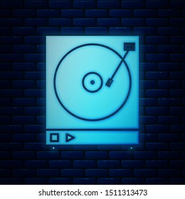 Glowing neon Vinyl player with a vinyl disk icon isolated on brick wall background.  Vector Illustration