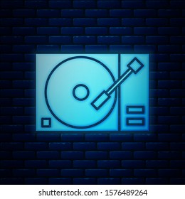 Glowing neon Vinyl player with a vinyl disk icon isolated on brick wall background.  Vector Illustration