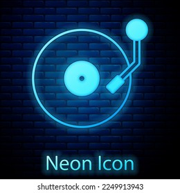 Glowing neon Vinyl player with a vinyl disk icon isolated on brick wall background.  Vector